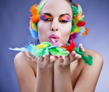 Beautiful young female face with bright fashion multicolored make-up &