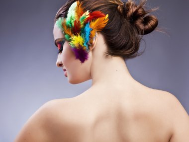 Beautiful young female face with bright fashion multicolored make-up &