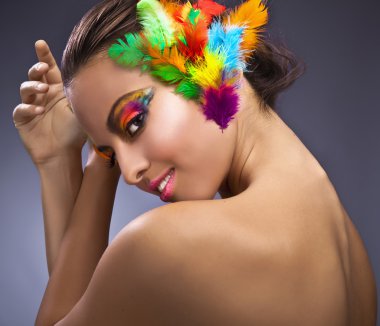 Beautiful young female face with bright fashion multicolored make-up &