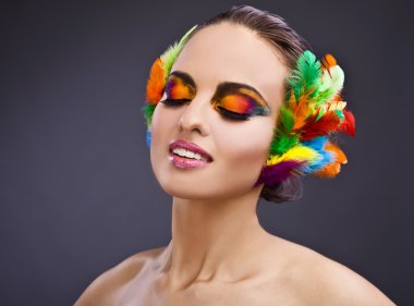 Beautiful young female face with bright fashion multicolored make-up &