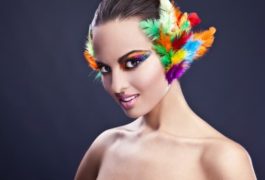 Beautiful young female face with bright fashion multicolored make-up &