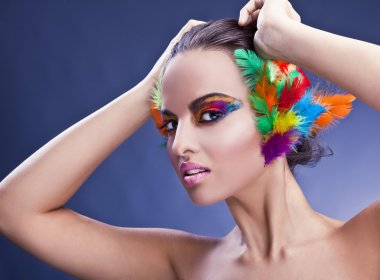 Beautiful young female face with bright fashion multicolored make-up &