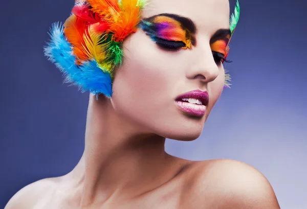Beautiful young female face with bright fashion multicolored make-up & — Stock Photo, Image