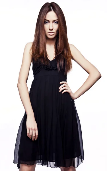 Gyönyörű lány, fekete klasszikus ruha. — Stock Fotó