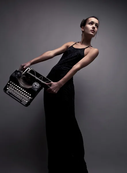 Elegant woman pose with ancient typewriter. — Stock Photo, Image