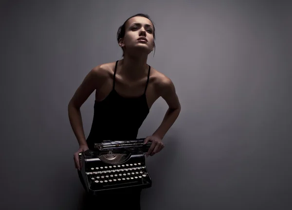 Mujer elegante pose con máquina de escribir antigua . —  Fotos de Stock