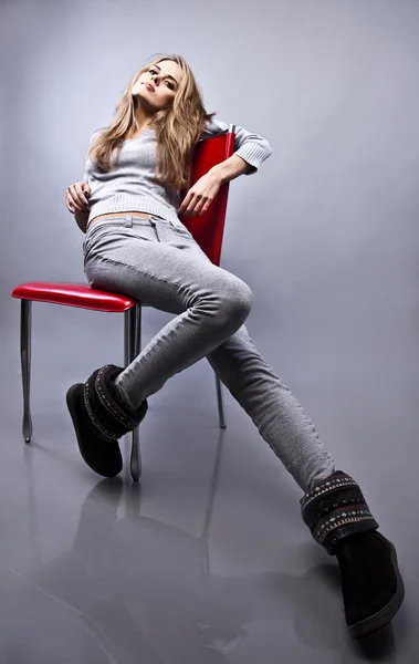 Gorgeous young woman sitting on a chair — Stock Photo, Image