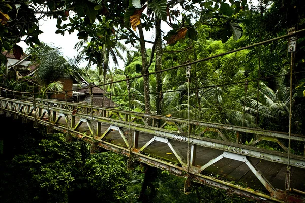 Old suspension walk bridge across river — Stock Photo, Image