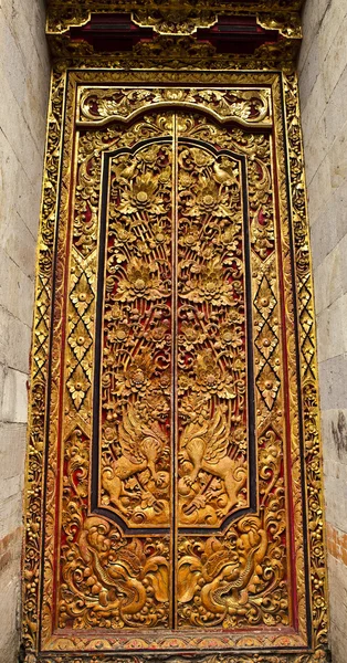 stock image Old wooden door with ornaments In Bali.