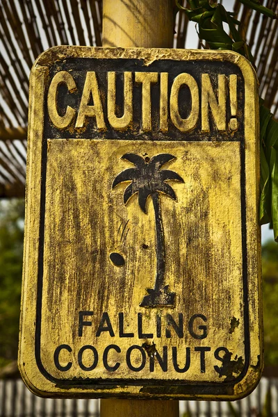 stock image Old funny wooden caution sign on the beach.