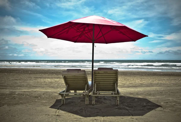 Red beach umbrella and deck chairs on the white sand. Tropical paradise on — Stock Photo, Image