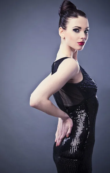 Mulher bonita no vestido clássico preto posar em estúdio. — Fotografia de Stock