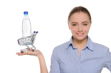 Bottle of water in shopping trolley on the palm clipart