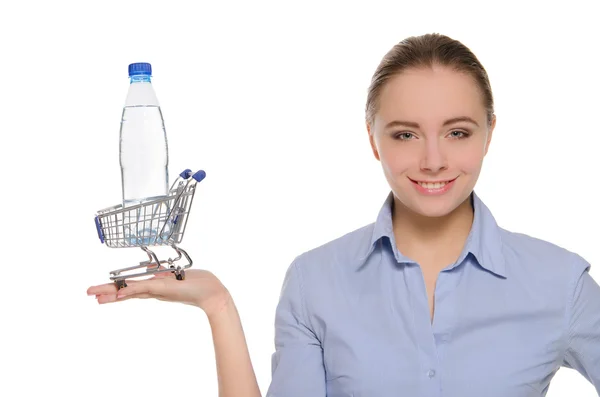 Bottle of water in shopping trolley on the palm — Stock Photo, Image