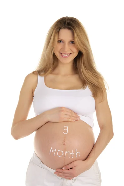 Беременная женщина с надписью на животе — стоковое фото