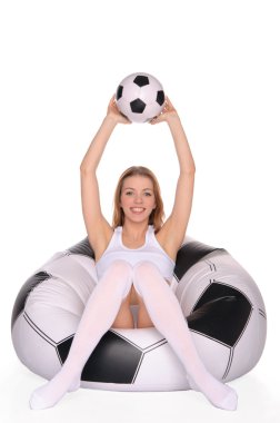 Woman with soccer ball on an inflatable chair clipart