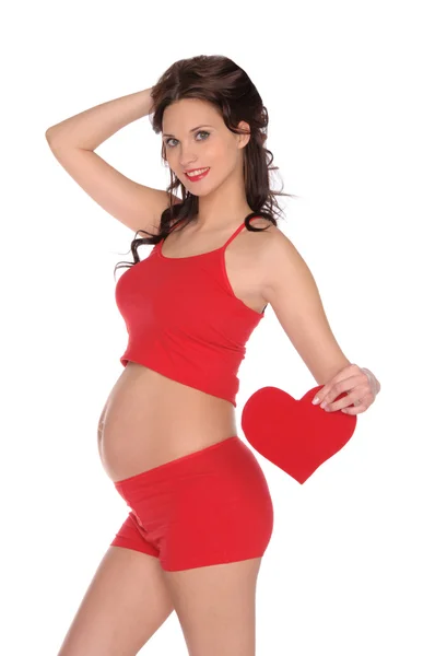Piękna kobieta w ciąży w czerwonym sercem — Zdjęcie stockowe