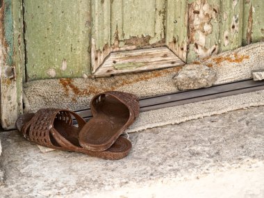 Plastic slippers at the doorstep clipart