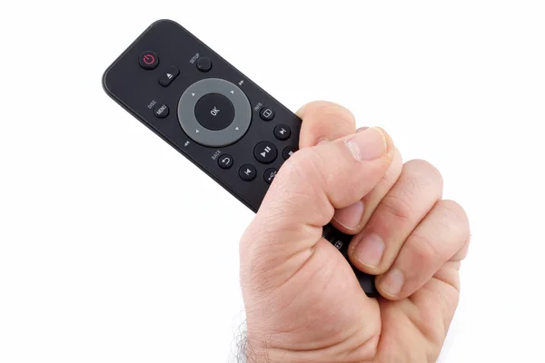 Hand som håller TV-fjärrkontrollen — Stockfoto