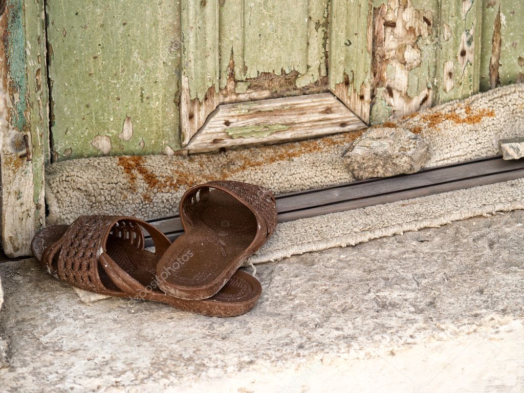 Plastic slippers at the doorstep Stock Photo by ©portokalis 9636411
