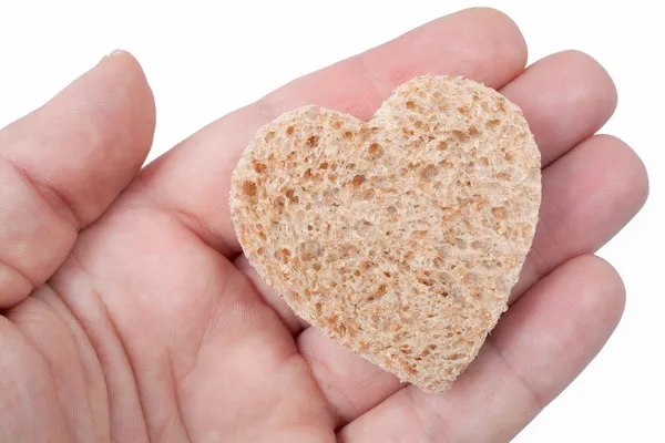 Um pedaço de pão oferecido com amor isolado em branco — Fotografia de Stock