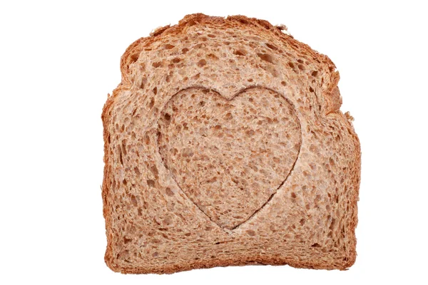Heart shaped hole in a slice of bread — Stock Photo, Image
