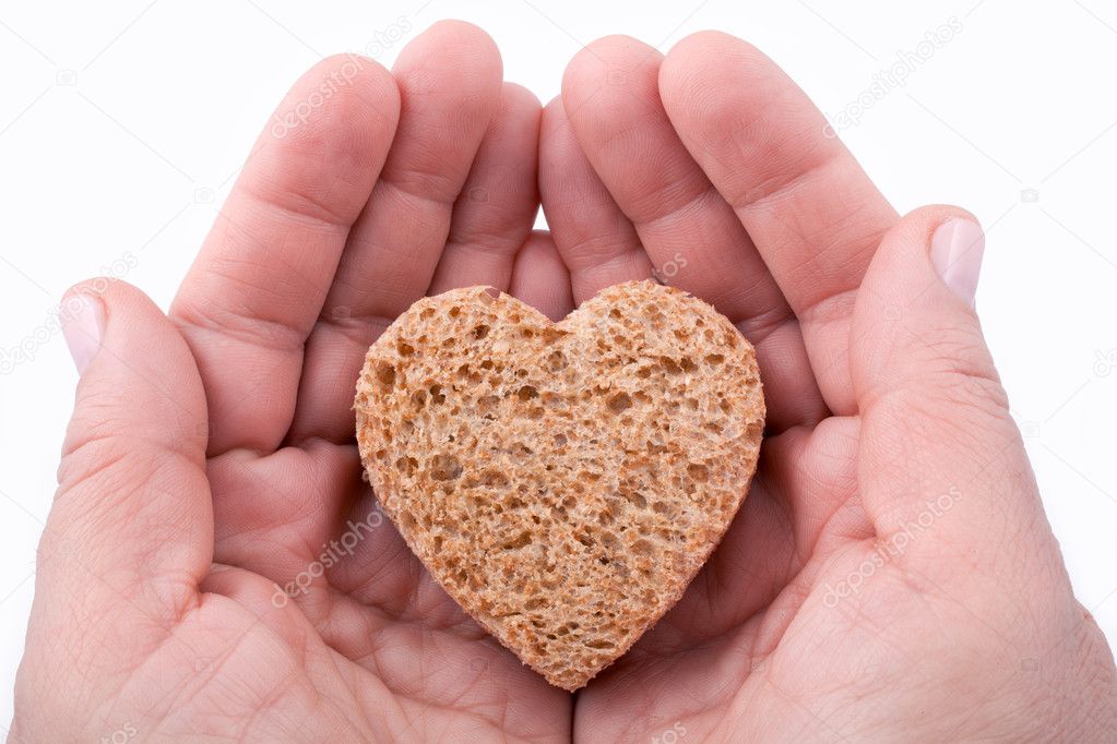 A piece of bread offered with love - isolated on white