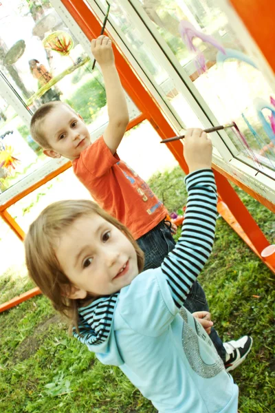 Children are drawing on glass outdoors — Stock Photo, Image