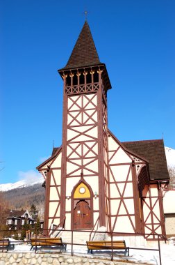 The old wooden Catholic church at ski resort, Tatranska Lomnica, clipart