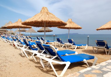 Sunbeds at the beach of luxury hotel, Crete, Greece clipart