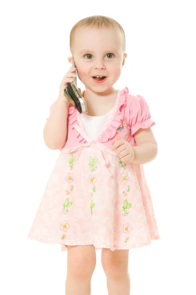 Little girl talking on the phone in a pink dress — Stock Photo, Image