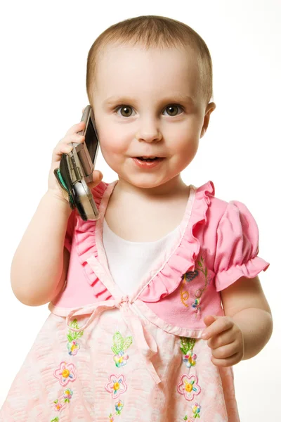 小女孩穿着粉色衣服电话上谈了 — 图库照片