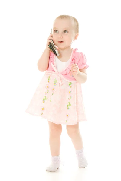 핑크 드레스에 전화 통화 하는 어린 소녀 — 스톡 사진