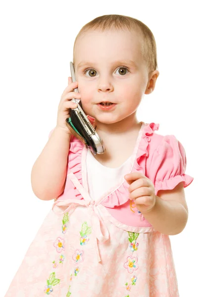 Little girl talking on the phone in a pink dress — Stock Photo, Image