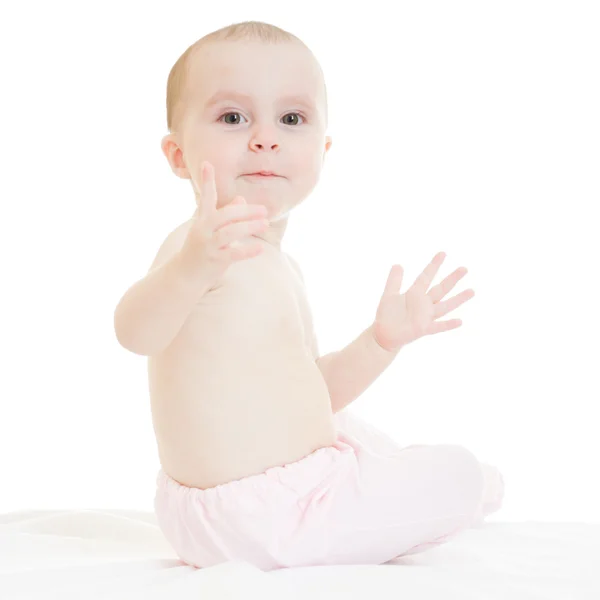 Ευτυχισμένο μωρό σε λευκό φόντο υποδεικνύει ένα δάχτυλο. — Φωτογραφία Αρχείου