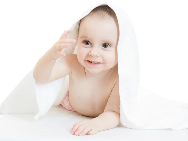 흰색 바탕에 수건 아래 행복 한 아기. — 스톡 사진