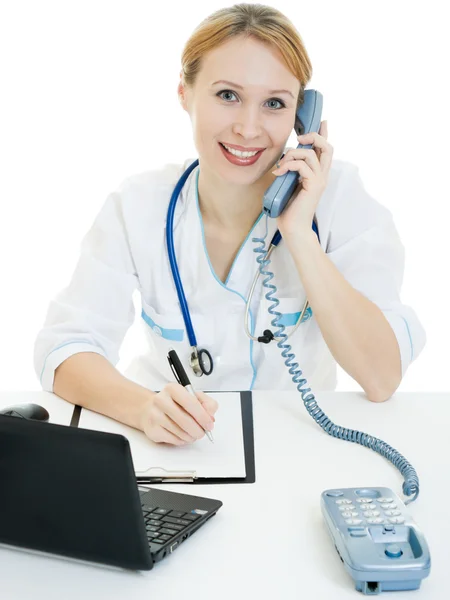 A woman doctor consultant with a laptop on a white background. Stock Photo