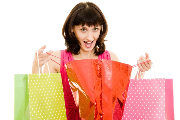 Menina com compras no vestido vermelho no fundo branco . — Fotografia de Stock