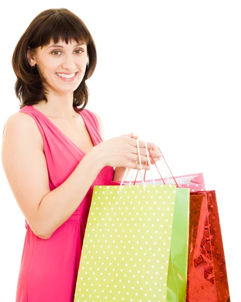 Mädchen mit Shopping im roten Kleid auf weißem Hintergrund. — Stockfoto