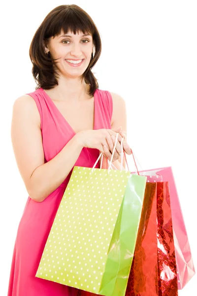 Dívka s nákupy v červených šatech na bílém pozadí. — Stock fotografie