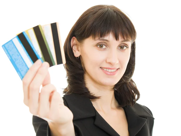 Mulher com muitos cartões de crédito diferentes. Isolado em branco . — Fotografia de Stock