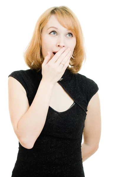 Surprised woman in a black dress on white background. — Stock Photo, Image