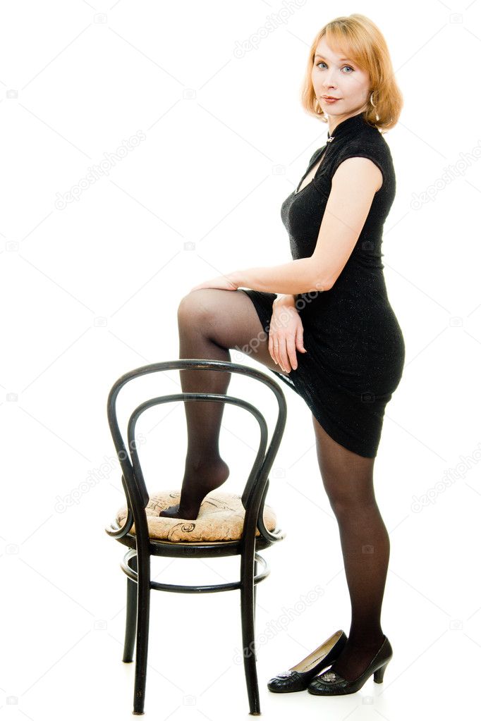 Portrait of a beautiful woman with a chair on a white background.