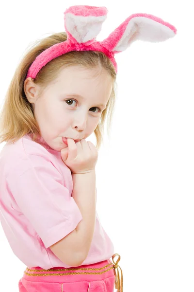 The little girl with pink ears bunny looks hurt on white background. — Stock Photo, Image