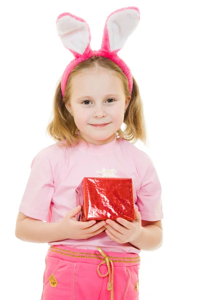 The little girl with pink ears bunny with a gift on a white background. — Stock Photo, Image
