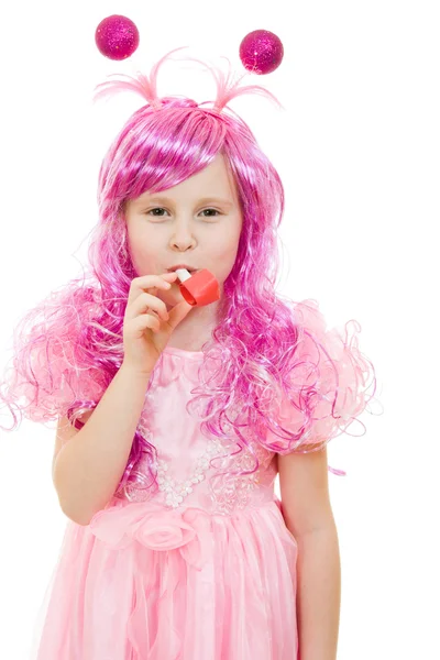 A girl with pink hair in a pink dress blowing a whistle on a white backgrou — Stock Photo, Image