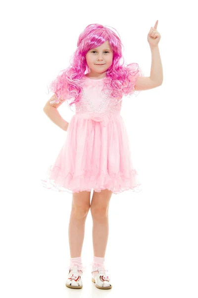 A girl with pink hair in a pink dress points to the top on a white backgrou — Stock Photo, Image