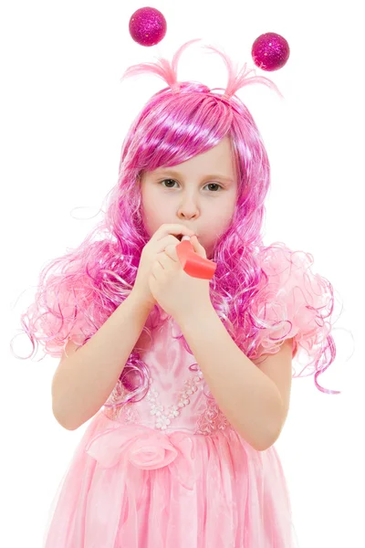 A girl with pink hair in a pink dress blowing a whistle on a white backgrou — Stock Photo, Image