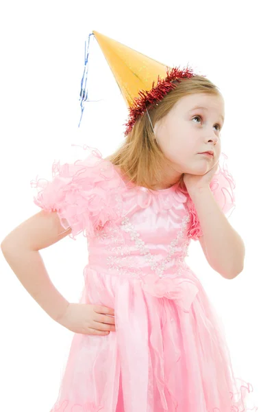 A girl in a pink dress and hat dreams on a white background. — Stock Photo, Image
