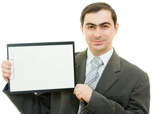 Um homem de negócios com uma folha de papel branca em branco sobre um fundo branco . — Fotografia de Stock